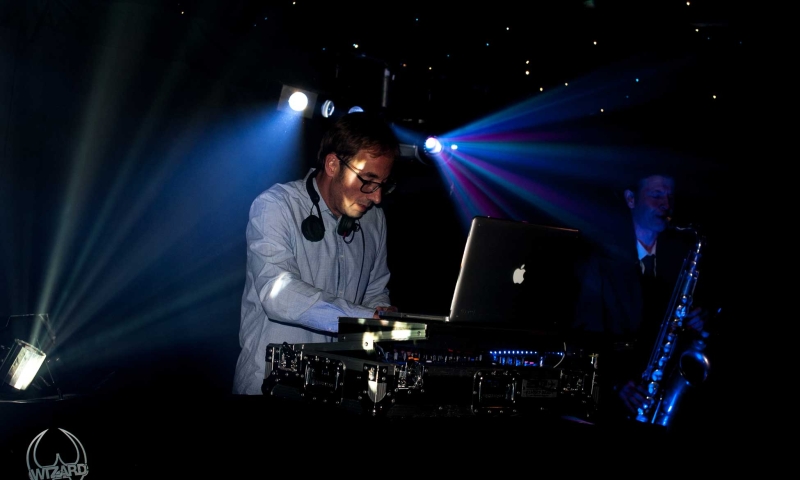 Picture of a DJ playing with a Sax and Bongo Player