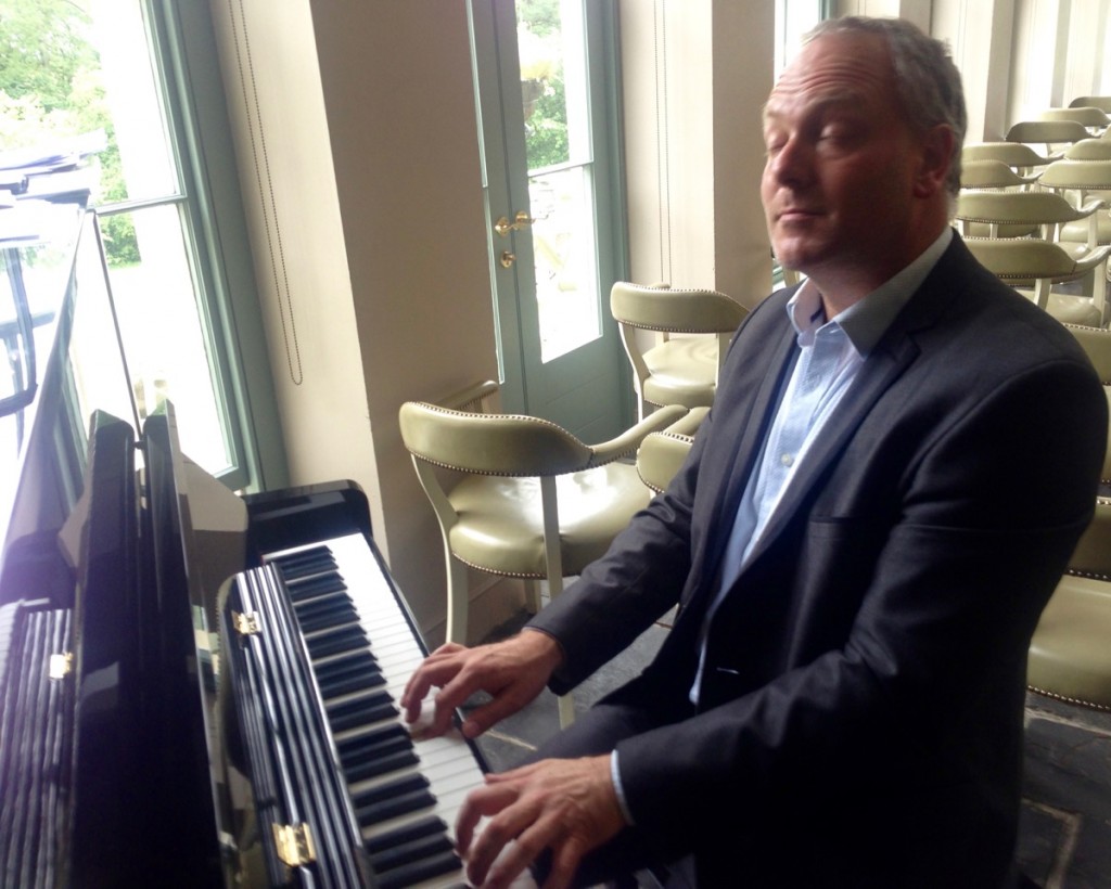 Image of a Pianist playing on an upright piano