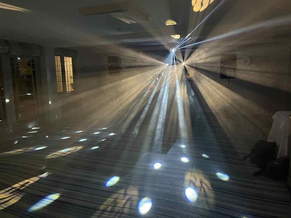 Professional dance floor lighting design with white LED effects creating a vibrant party atmosphere