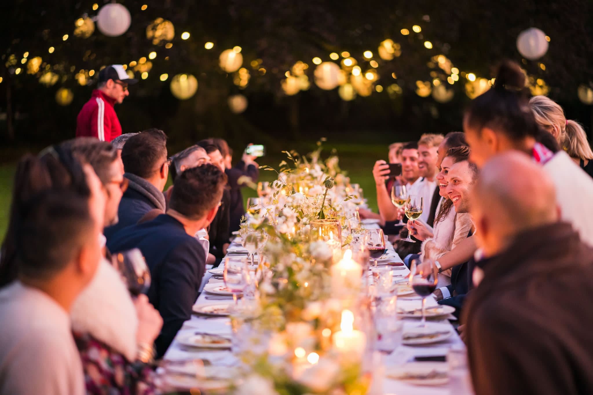 Exterior dining with tree lighting for alfresco wedding or corporate dinner