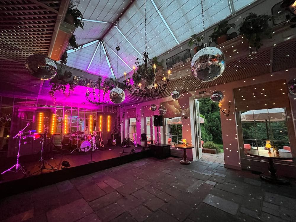 Mirror balls and staging with colourful party lighting creating a classic disco atmosphere
