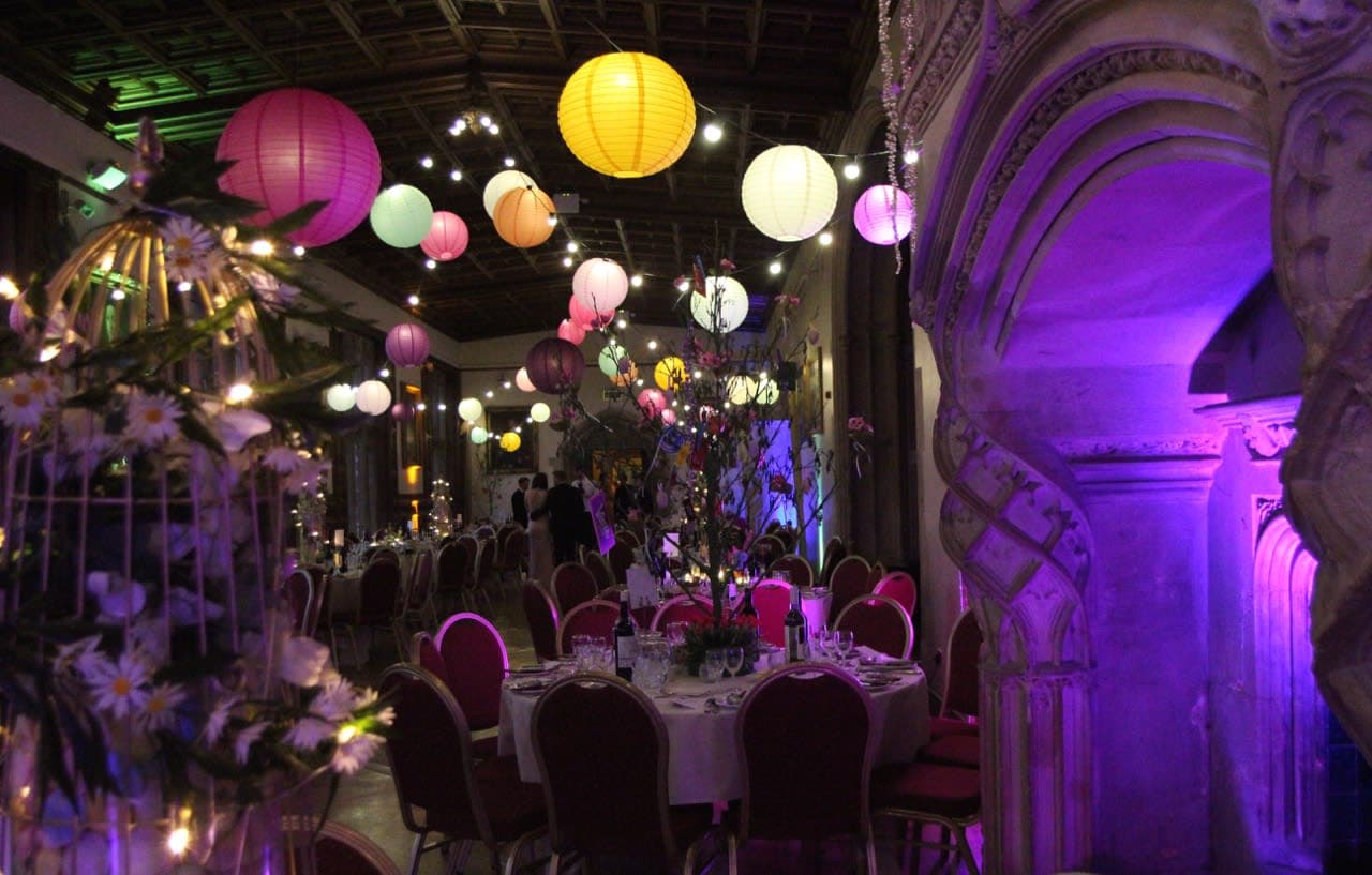 Ashton Court Mansion exterior illuminated with colourful party lighting for an evening event