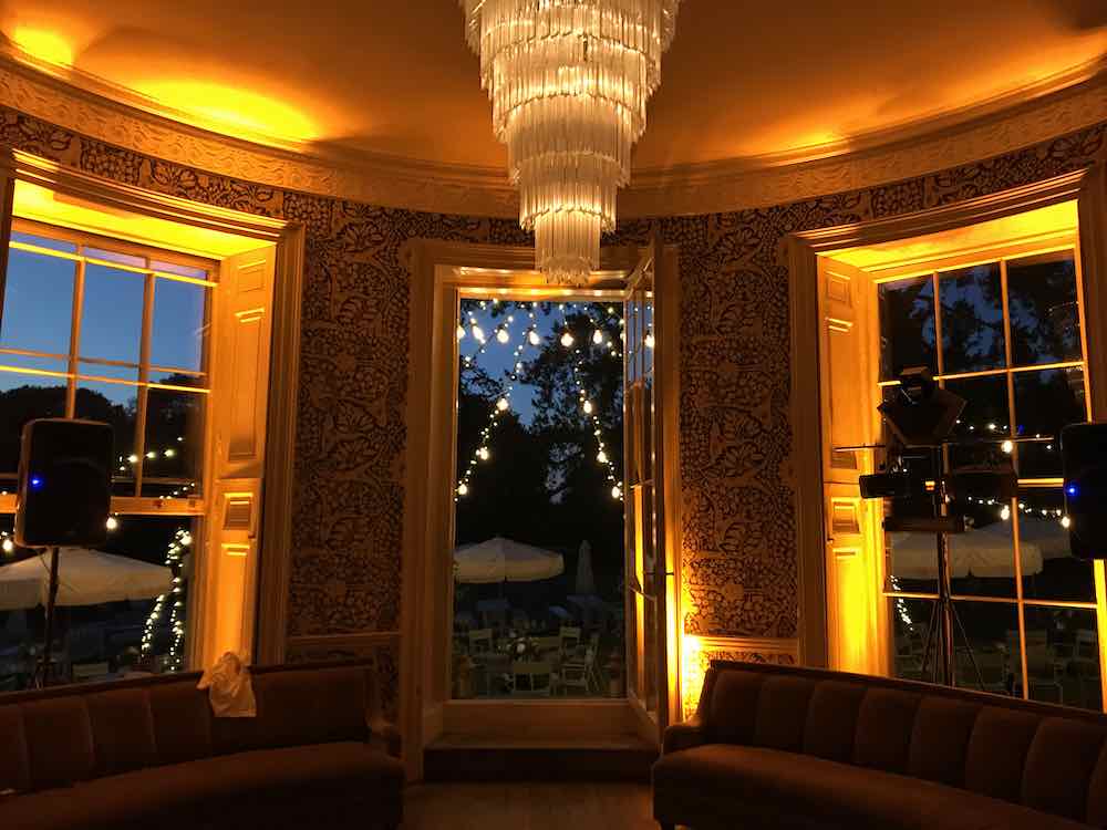 Amber LED mood lighting washing venue walls and columns for a sophisticated party look