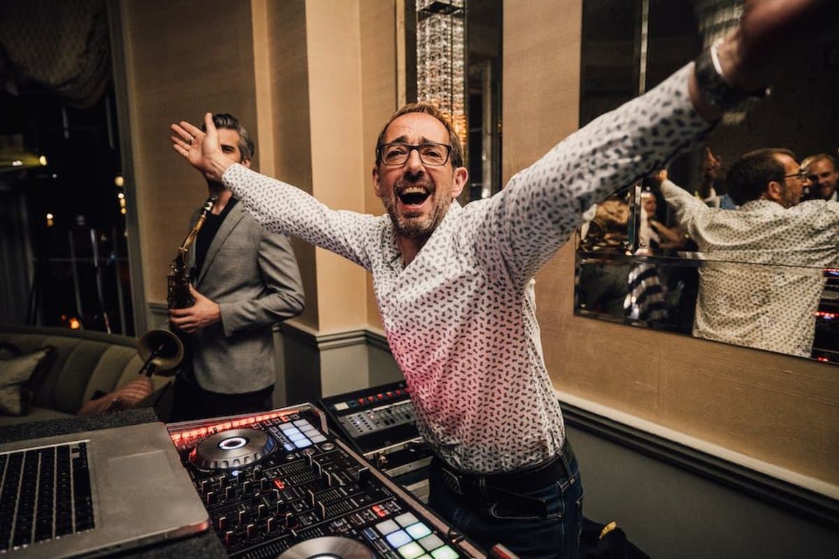 DJ performing at Babington House with elegant lighting—wedding and event entertainment