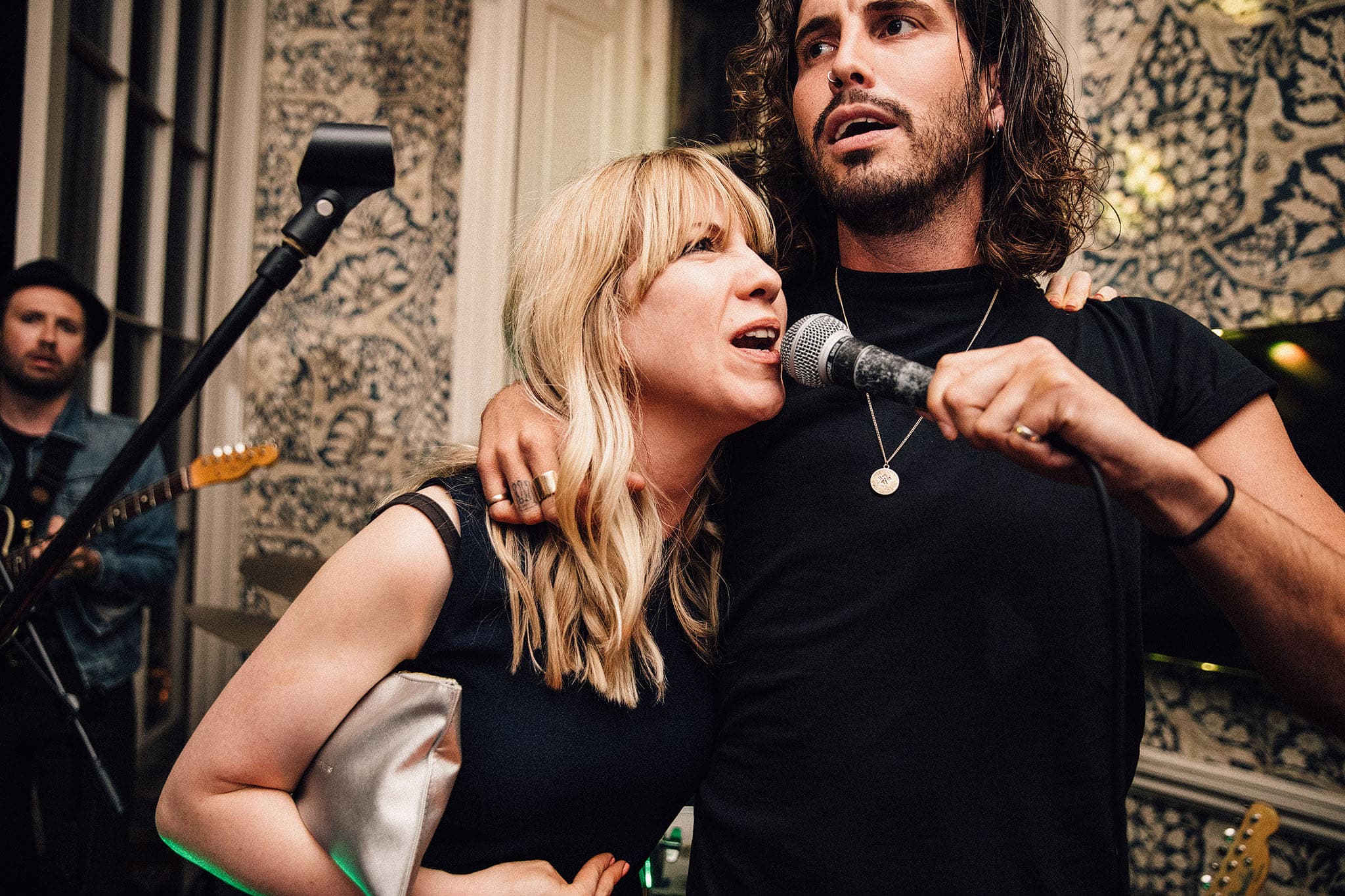 Live musicians performing at a wedding, showcasing saxophone and percussion