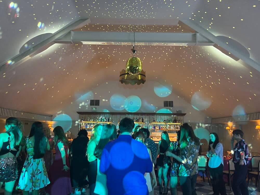 A party in full swing with DJ and Mirrorball lighting at Kin House