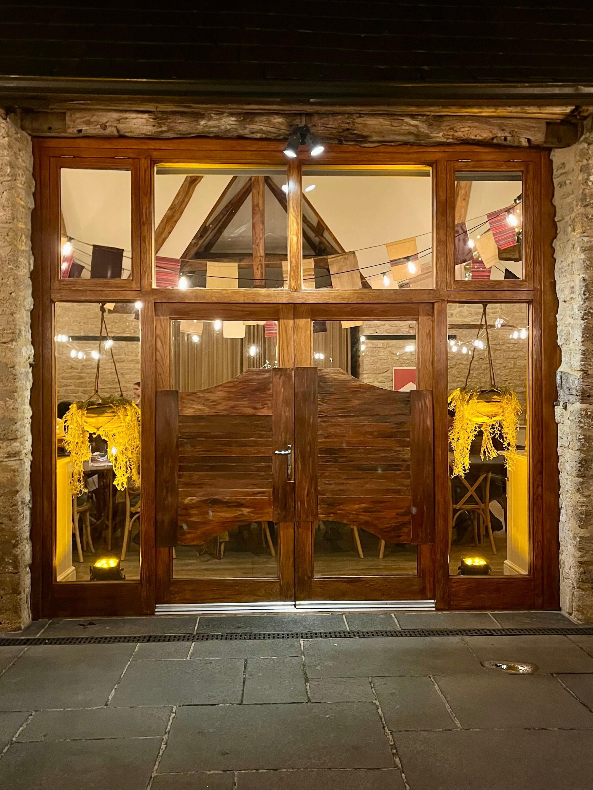 Wild West themed photo backdrop with cowboy props and rustic styling at a private party