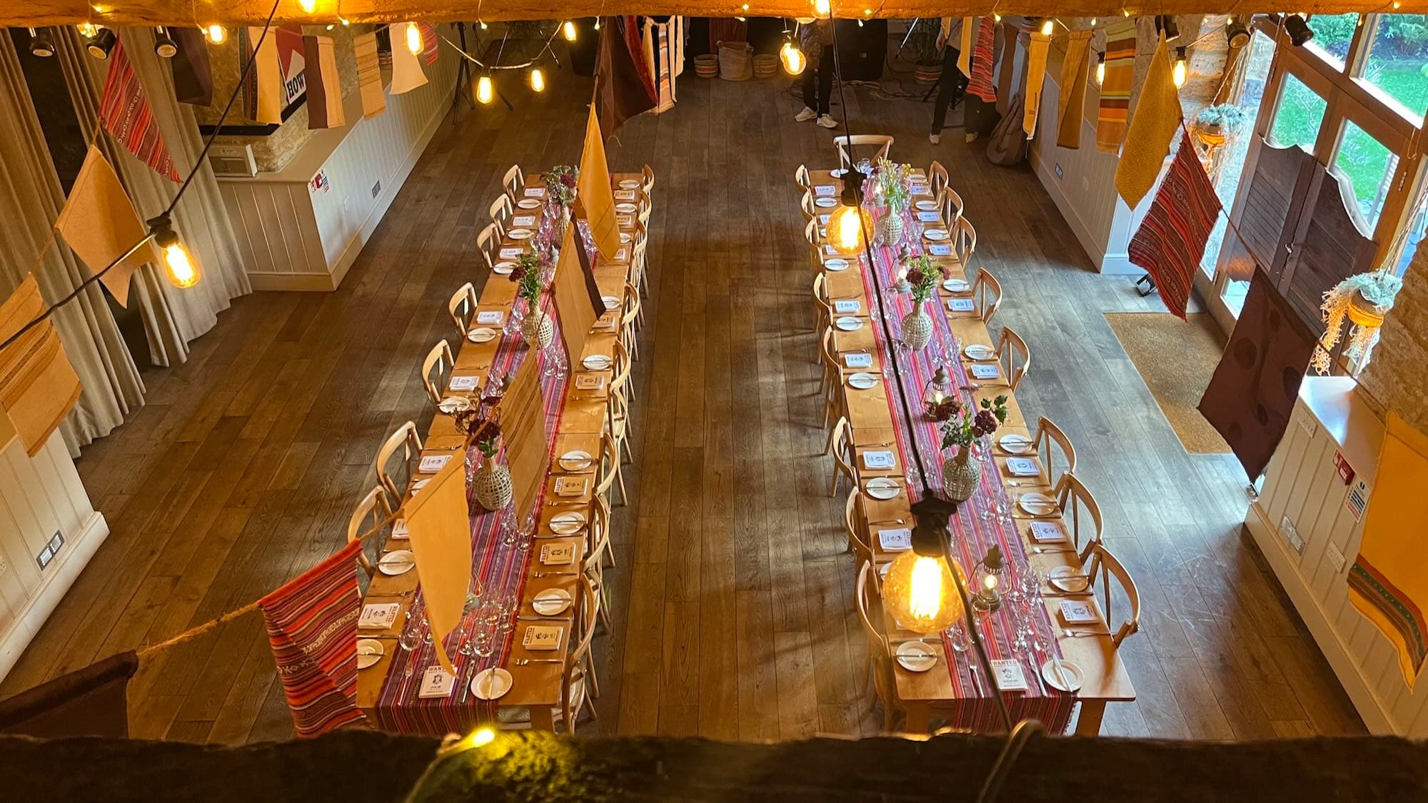 Outdoor Wild West themed patio with fire pit, hay-bale seating and festoon lights at a private party