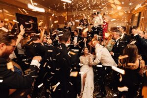 A bar at night, wedding party, bride in the centre with confetti in the air,