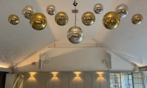 Kin House WIltshire with mixed colour mirrorballs in a line.