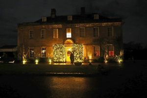Babington House Wedding fairy-lights in the bushes at the front of the house.