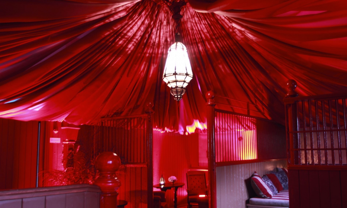 Image of a red canopied ceiling in a stable
