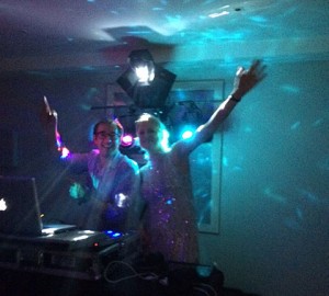 DJ Nigel Peirce behind the DJ decks with a lady with her arms int he air at Hotel Tresanton in Cornwall