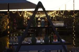 Dusk, A frame bar in foreground, blurred fairy-lights streth front to back