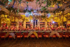 24 Mirror-balls were installed into this room along with vines and amazing floristry with a large table with red seating,